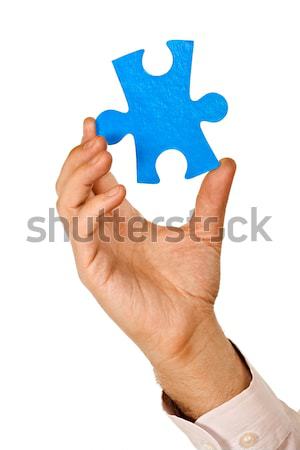 Businessman holding a piece of puzzle Stock photo © joseph73
