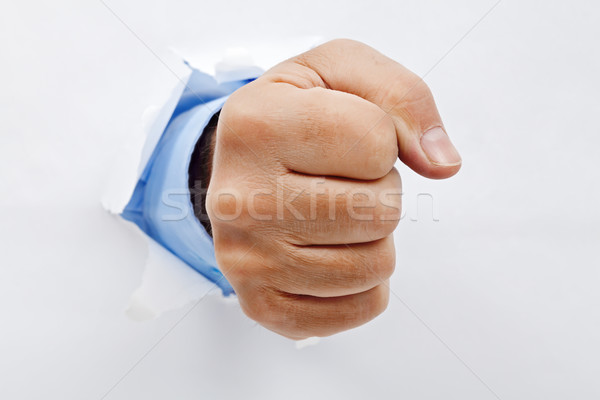 Businessman fist through the paper Stock photo © joseph73