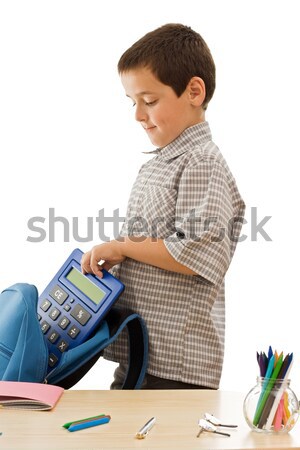 Schoolboy putting an exercise book in the schoolbag Stock photo © joseph73