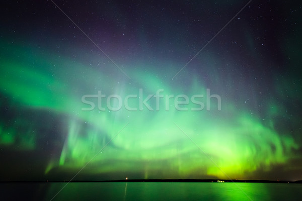 Northern lights over lake in finland Stock photo © Juhku