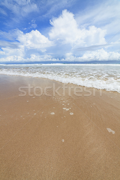 Waves sand beach and clouds sunny day Stock photo © Juhku