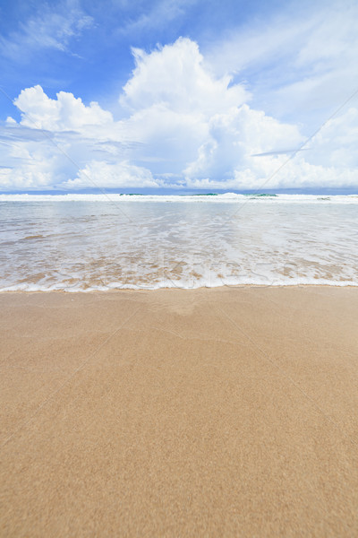 Waves sand beach and clouds sunny day Stock photo © Juhku