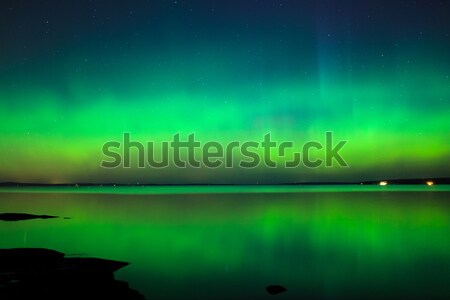 Northern lights over lake in finland Stock photo © Juhku