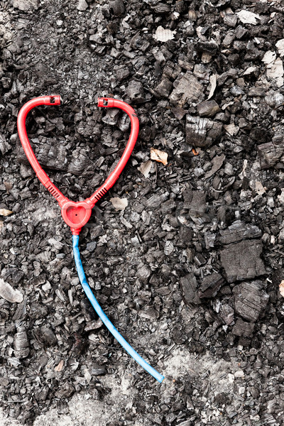 Plastic toy stethoscope on burned ground Stock photo © Juhku