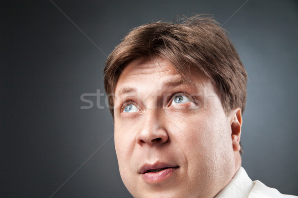 Close-up of adult man looking up in amazement Stock photo © julenochek