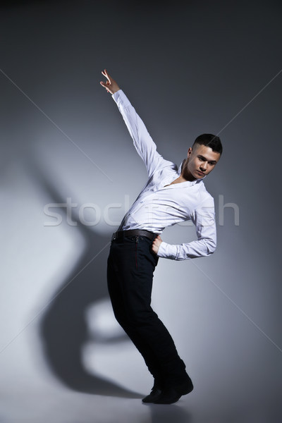 Stock photo: Modern style dancer posing on grey background