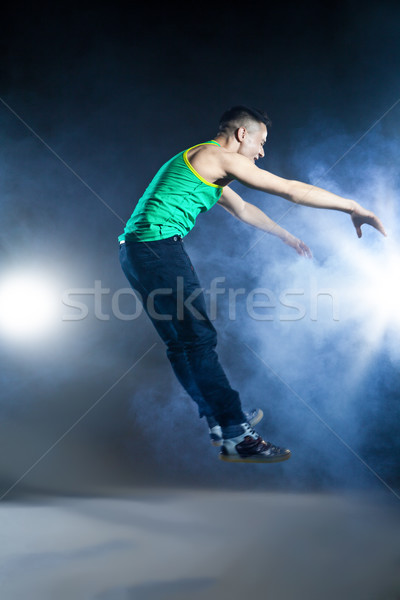 Dancer posing on background with flashes and smoke Stock photo © julenochek