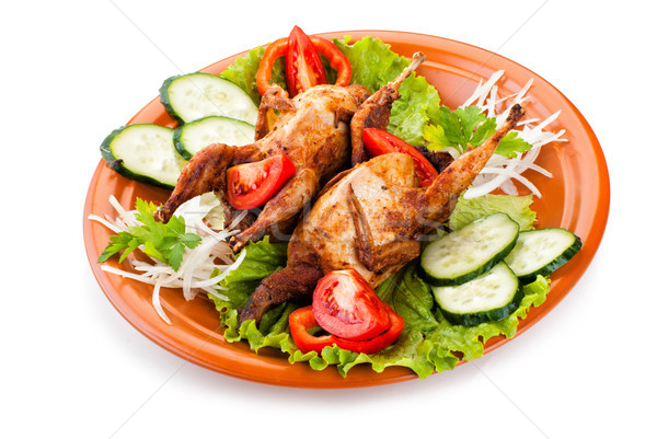 Two whole quail with cucumber, tomatoes and onion Stock photo © julenochek
