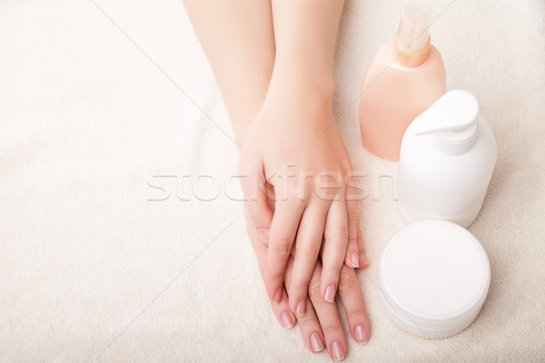 Woman's beautiful hands with care cream bottles Stock photo © julenochek