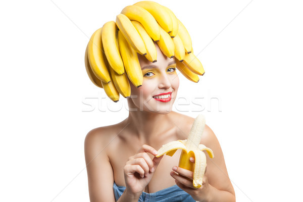 Studio shot of smiling woman peeling banana Stock photo © julenochek
