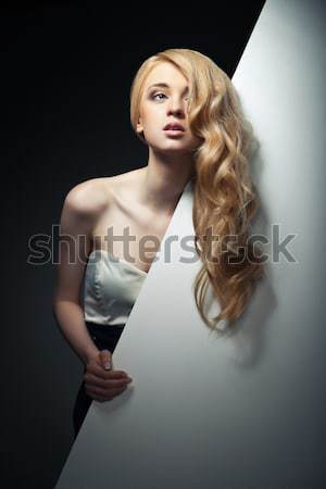Closeup portrait of blond model posing with hair fluttering in the wind Stock photo © julenochek