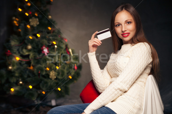 Woman with credit card in front of Christmas tree Stock photo © julenochek