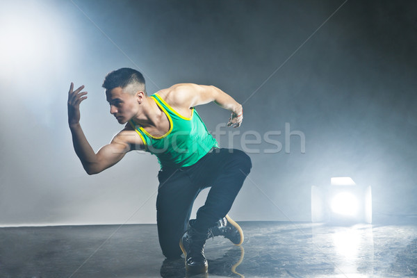 Dancer posing on background with flashes and smoke Stock photo © julenochek