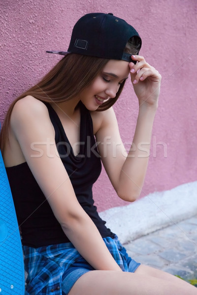 young girl wearing cap and shorts over pink wall Stock photo © julenochek