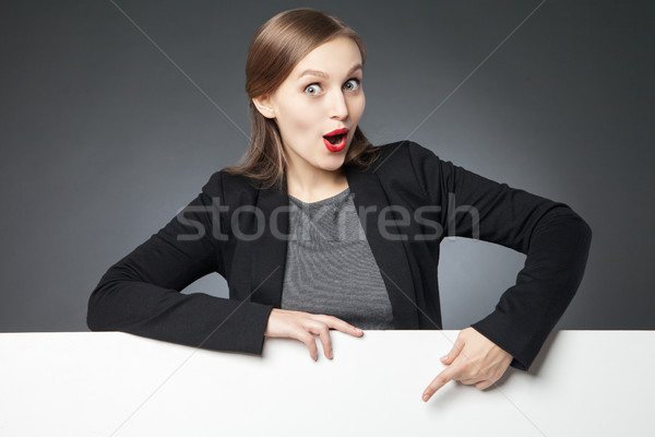 Astonished woman with red lips pointing at blank space Stock photo © julenochek