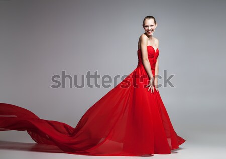 Young blonde girl in red dress with flying skirt Stock photo © julenochek