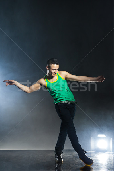 Dancer posing on background with flashes and smoke Stock photo © julenochek