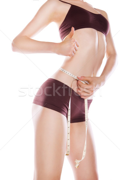 Woman measuring her waist by metric tape isolated Stock photo © julenochek