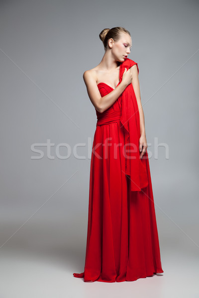 elegant woman in red dress holding cloth on shoulder Stock photo © julenochek