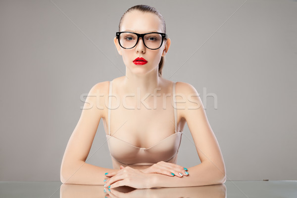 Calm young woman with red lips looking at camera Stock photo © julenochek