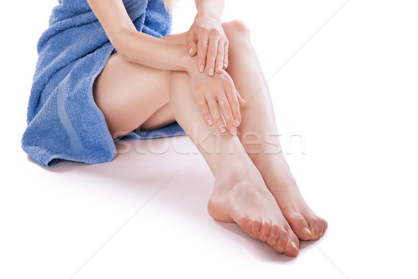 Woman in towel sitting on floor, stroking her legs Stock photo © julenochek