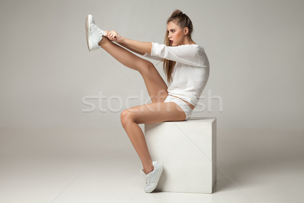 年輕女子 運動鞋 肖像 白 坐在 女孩 商業照片 © julenochek