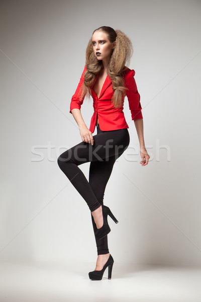 Model in red jacket and black heels looking away Stock photo © julenochek