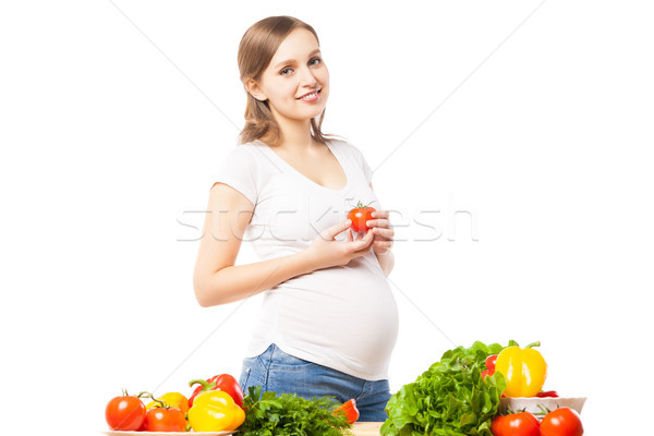 Feliz mulher tomates grávida sorrindo Foto stock © julenochek