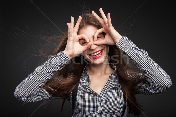 Woman making glasses out of her hands. Stock photo © julenochek