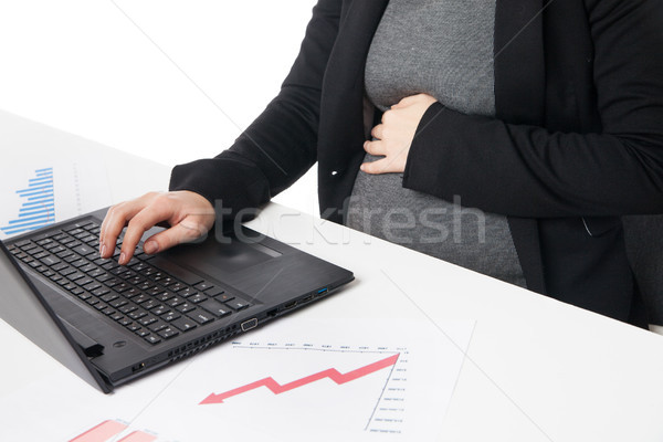 Businesswoman waiting for baby while working on laptop Stock photo © julenochek