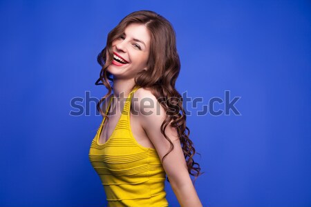 Happy jumping model in yellow dress with outstretched arms Stock photo © julenochek