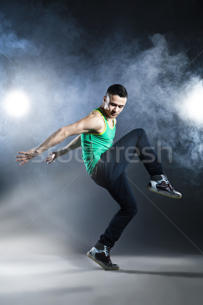 Dancer posing on background with flashes and smoke Stock photo © julenochek