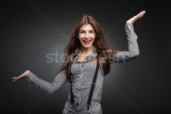 Stock photo: Joyful woman posing with her hands up