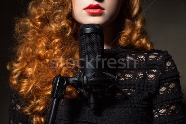 Stock photo: Close-up of curly-haired woman with mic