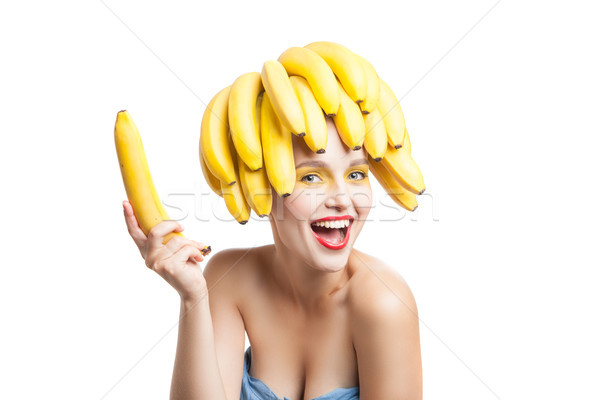 Excited model with bananas on head holding one in hand Stock photo © julenochek