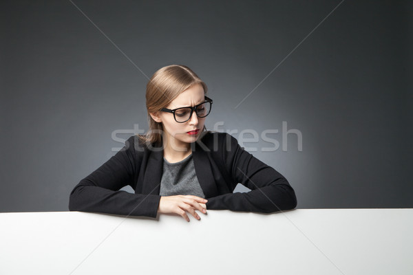 Smutne młoda kobieta okulary patrząc w dół portret Zdjęcia stock © julenochek