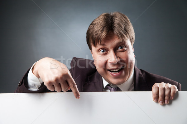 Adult businessman pointing at blank space Stock photo © julenochek