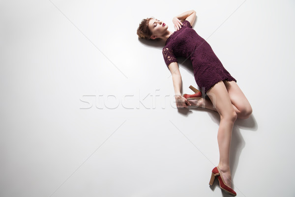 Woman in dress and heels posing on floor Stock photo © julenochek