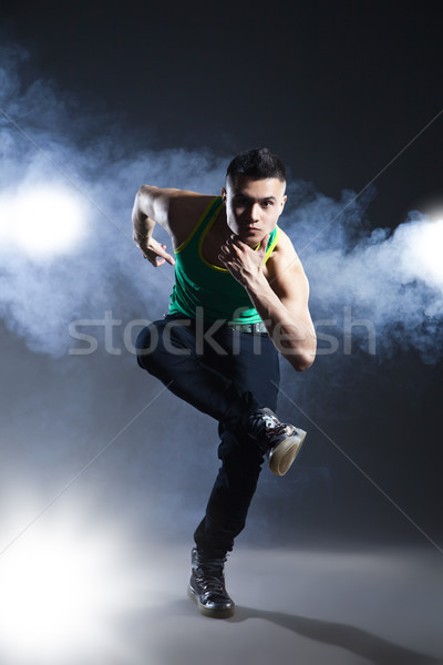 Dancer posing on background with flashes and smoke Stock photo © julenochek