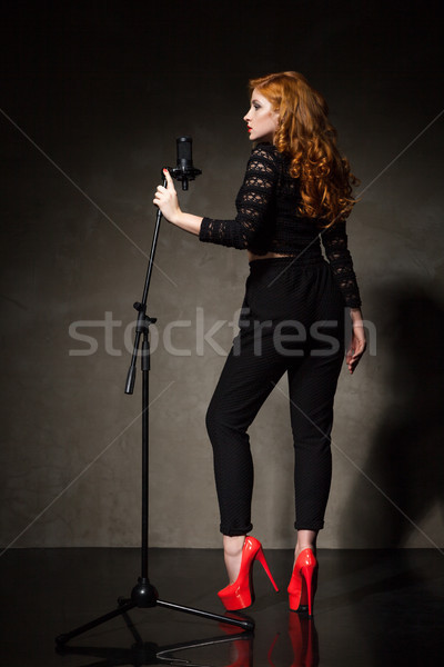 Diva in black and red heels signing song Stock photo © julenochek