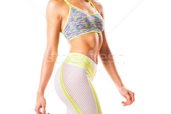 Crop sportive female posing on white background Stock photo © julenochek