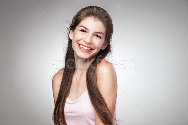 Portrait of smiling girl posing at camera. Stock photo © julenochek