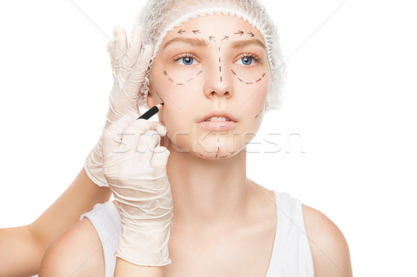 Hands in gloves painting outlines on girls face Stock photo © julenochek