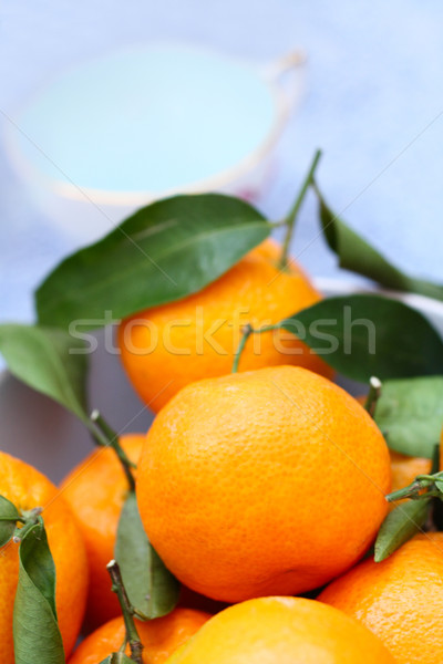 Ripe clementines on the blue, pastel plate  Stock photo © Julietphotography