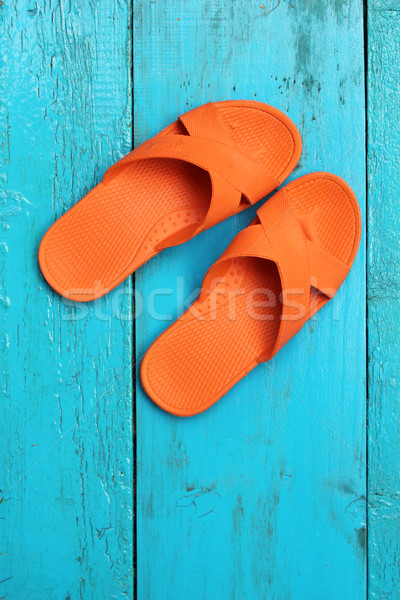 Orange flip flop sandals on blue wooden background Stock photo © Julietphotography