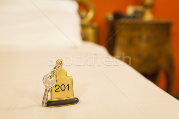 Hotel Room Key lying on Bed with keyring Stock photo © juniart