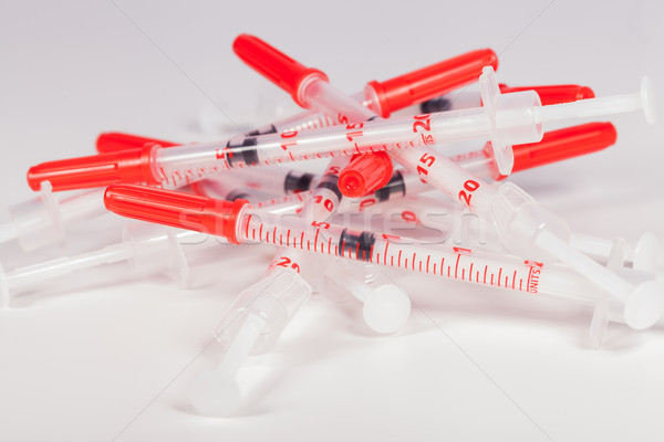 Pile of Empty Syringes with Red Safety Caps Stock photo © juniart