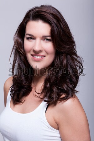 портрет красивая женщина темные волосы улыбаясь камеры серый Сток-фото © juniart
