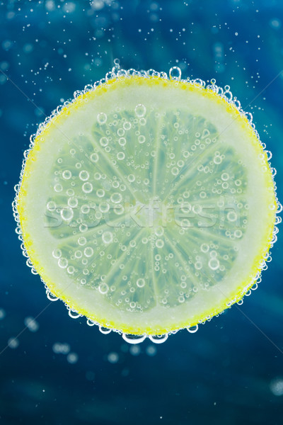 Lemon in carbonated water Stock photo © juniart