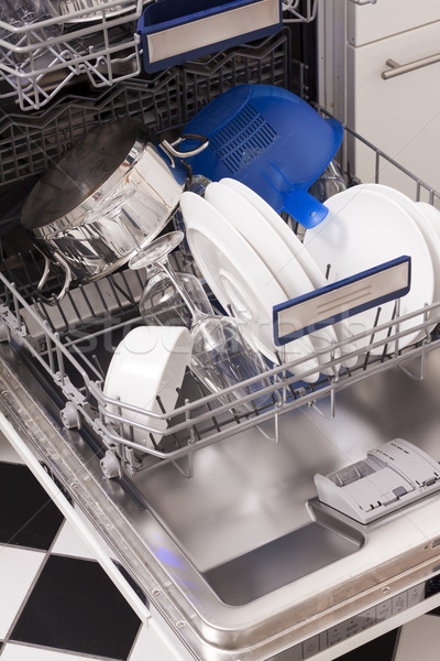 Dishwasher loades in a kitchen with clean dishes Stock photo © juniart